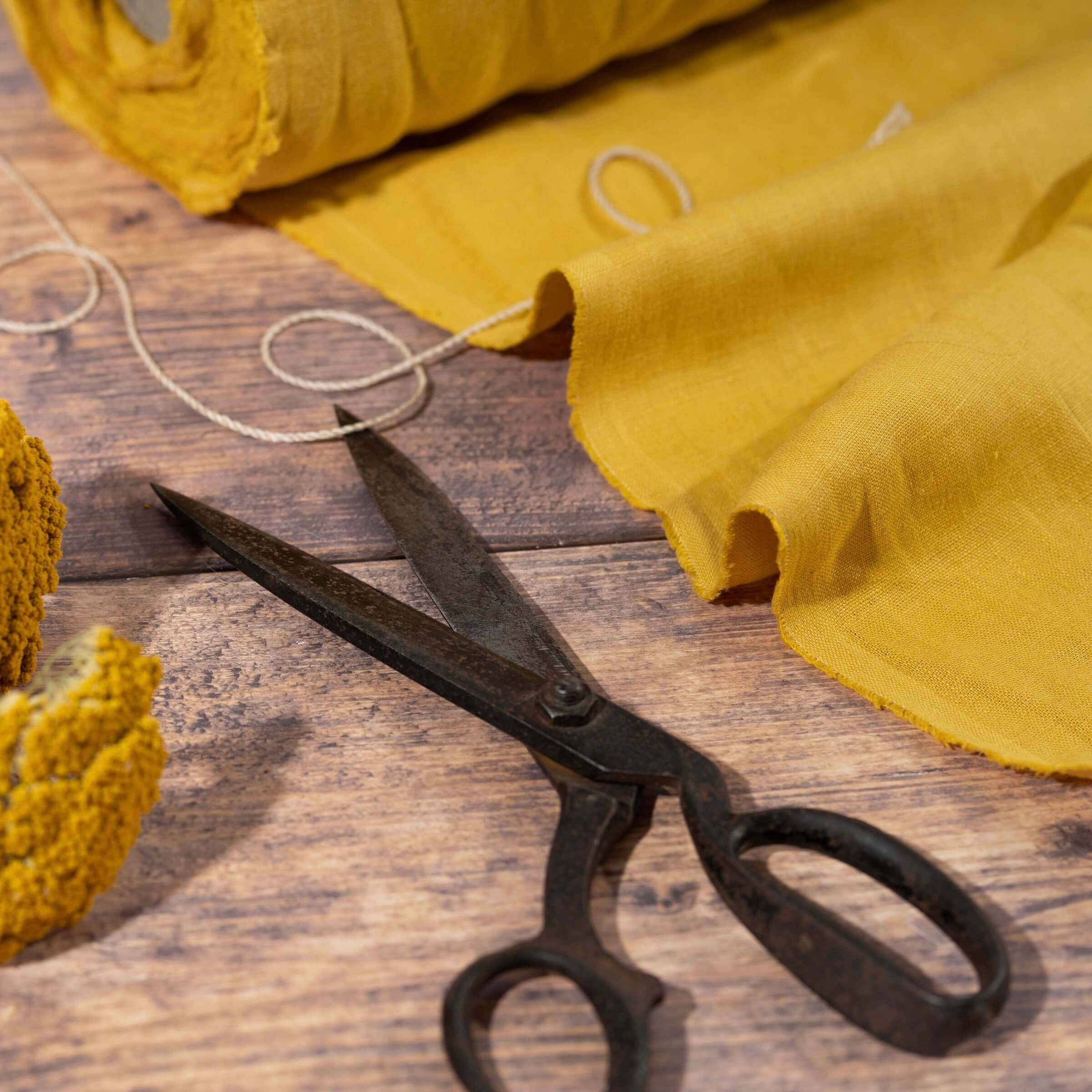 Honey Yellow linen fabric, ready to cut, with scissors, thread bobbins and flowers