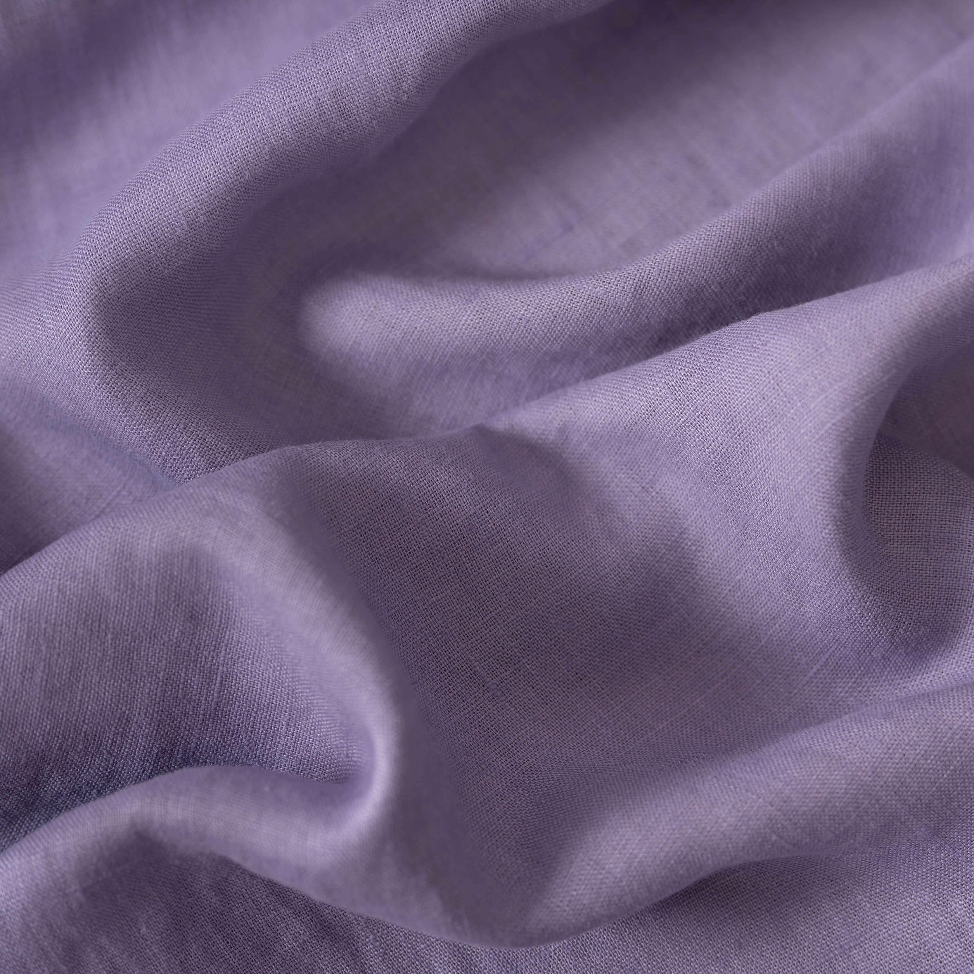 Lavender linen fabric, crumpled to show its natural texture, washed European flax