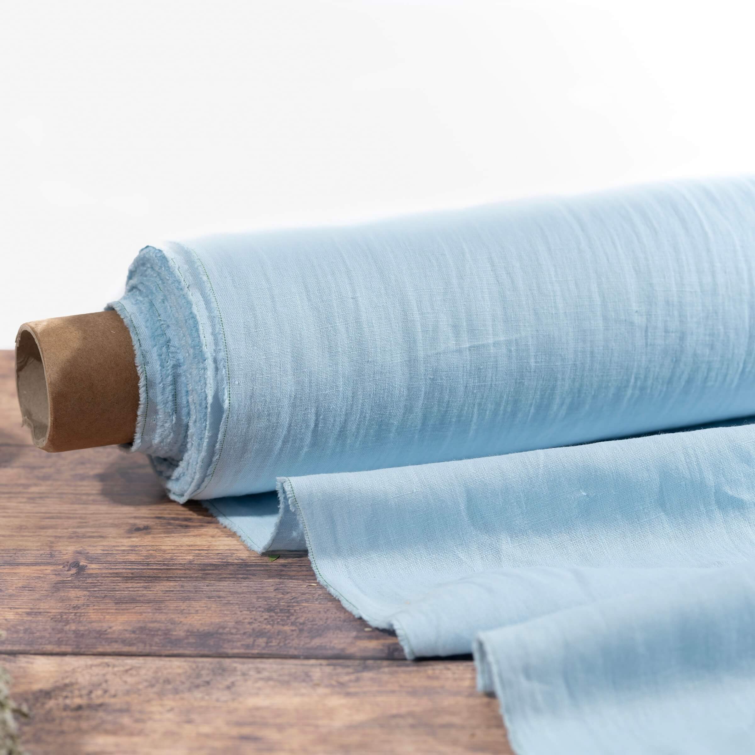 Light Sky Blue linen fabric, ready to cut, with scissors, thread bobbins and flowers