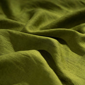 Moss Green linen fabric, crumpled to show its natural texture, washed European flax