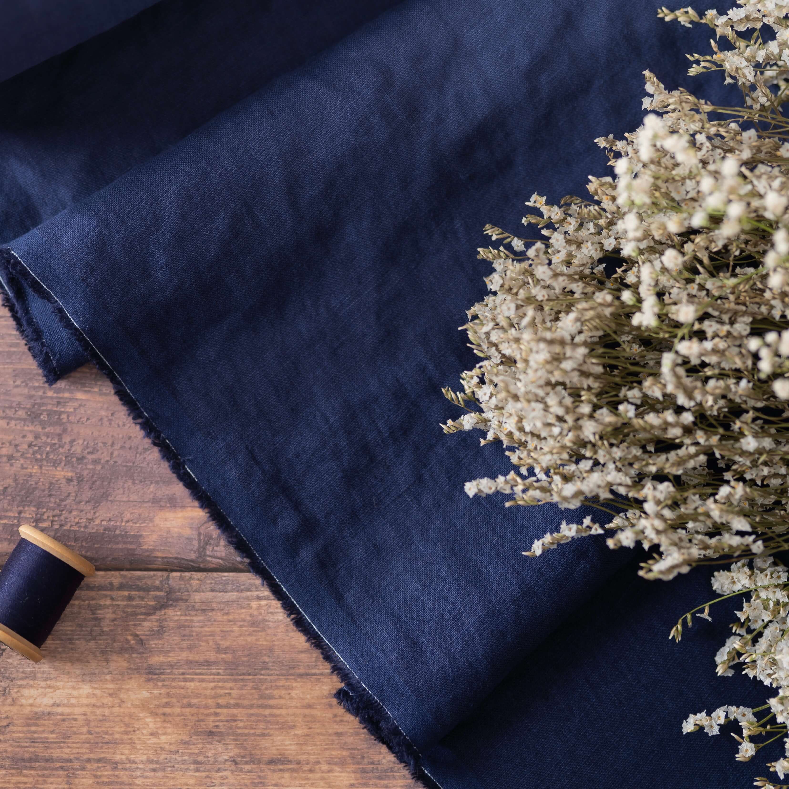 Navy Blue linen fabric, ready to cut, with thread bobbins and flowers