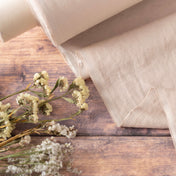 Oatmeal linen fabric, ready to cut, with scissors, thread bobbins and flowers