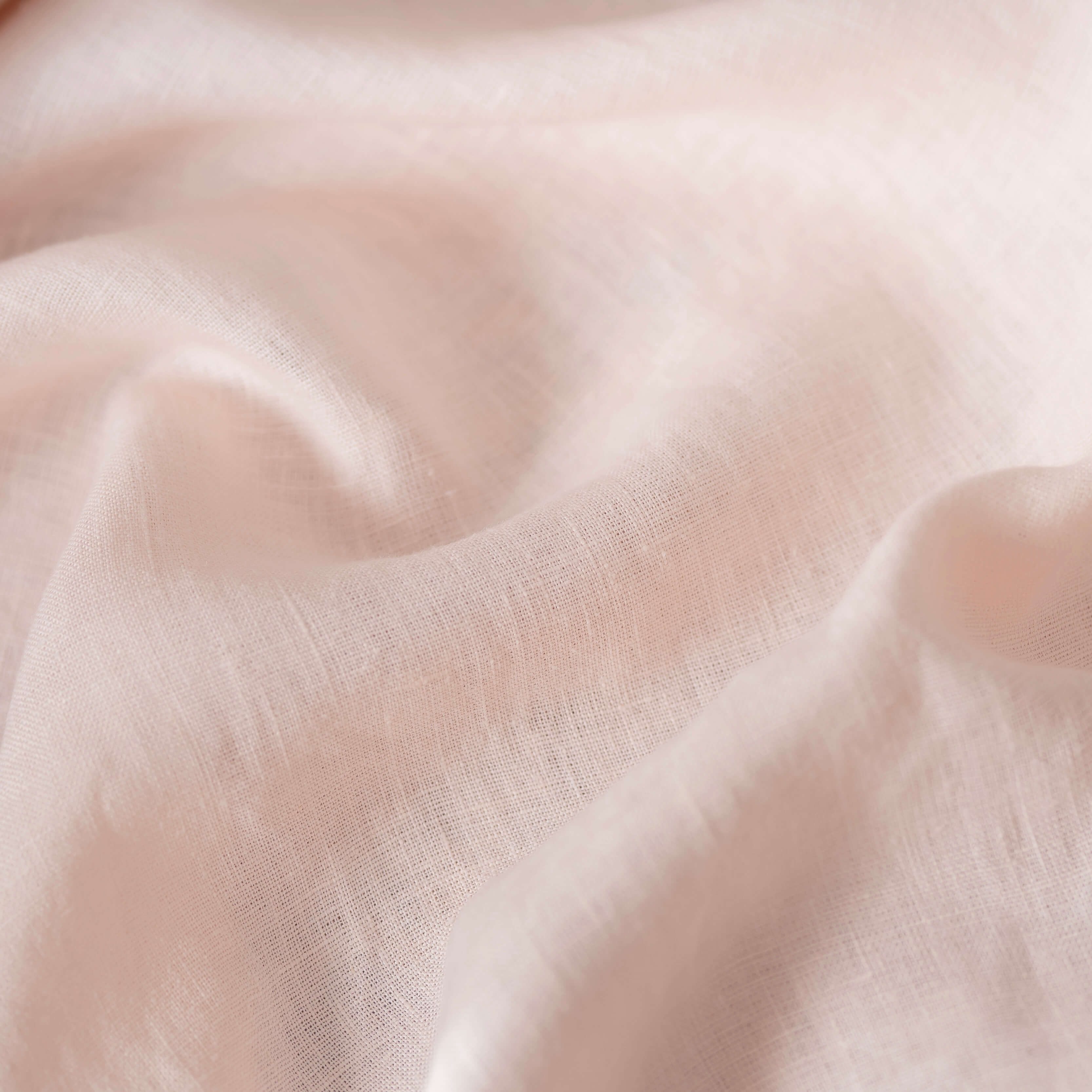 Pale Pink linen fabric, crumpled to show its natural texture, washed European flax