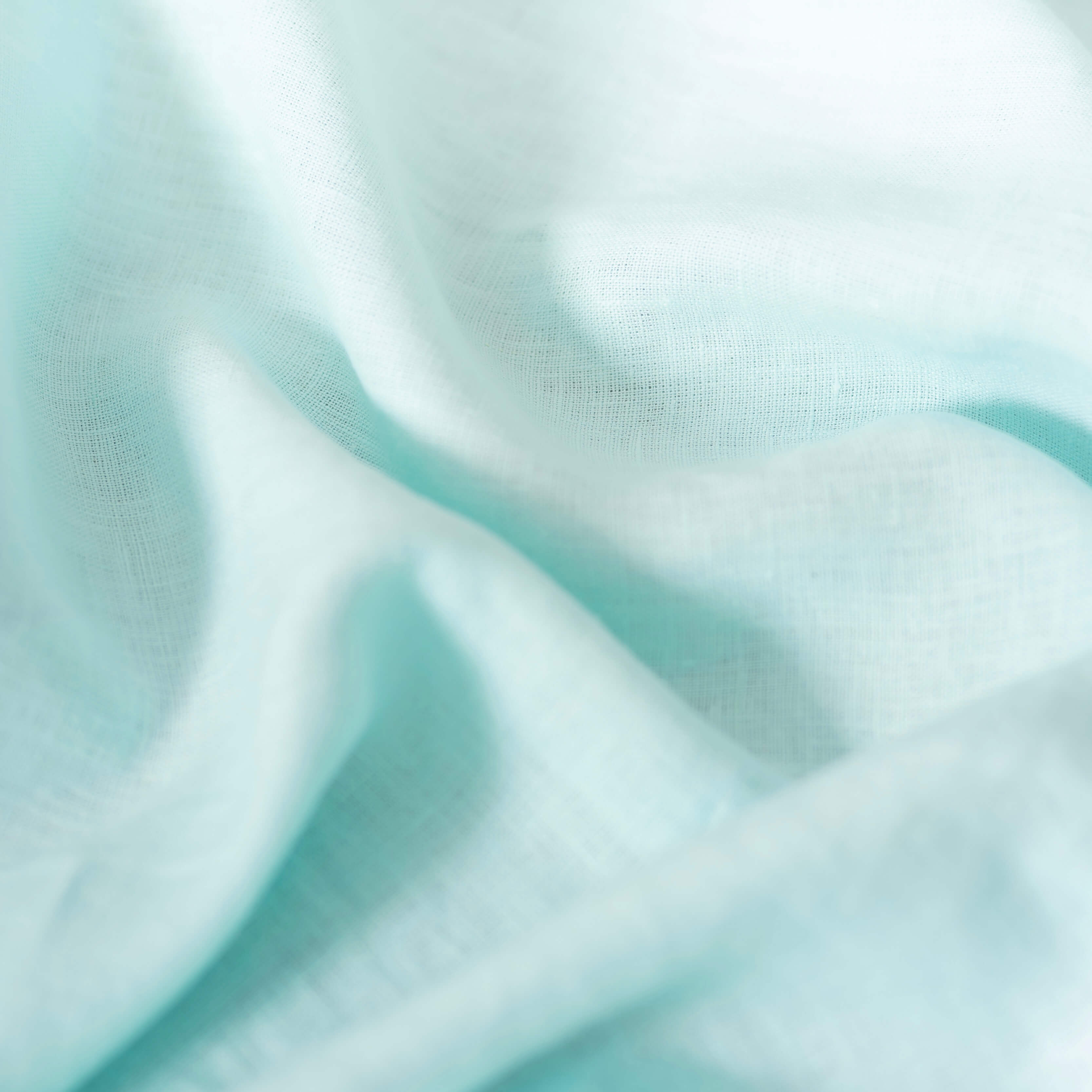 Pastel Light Mint linen fabric, crumpled to show its natural texture, washed European flax