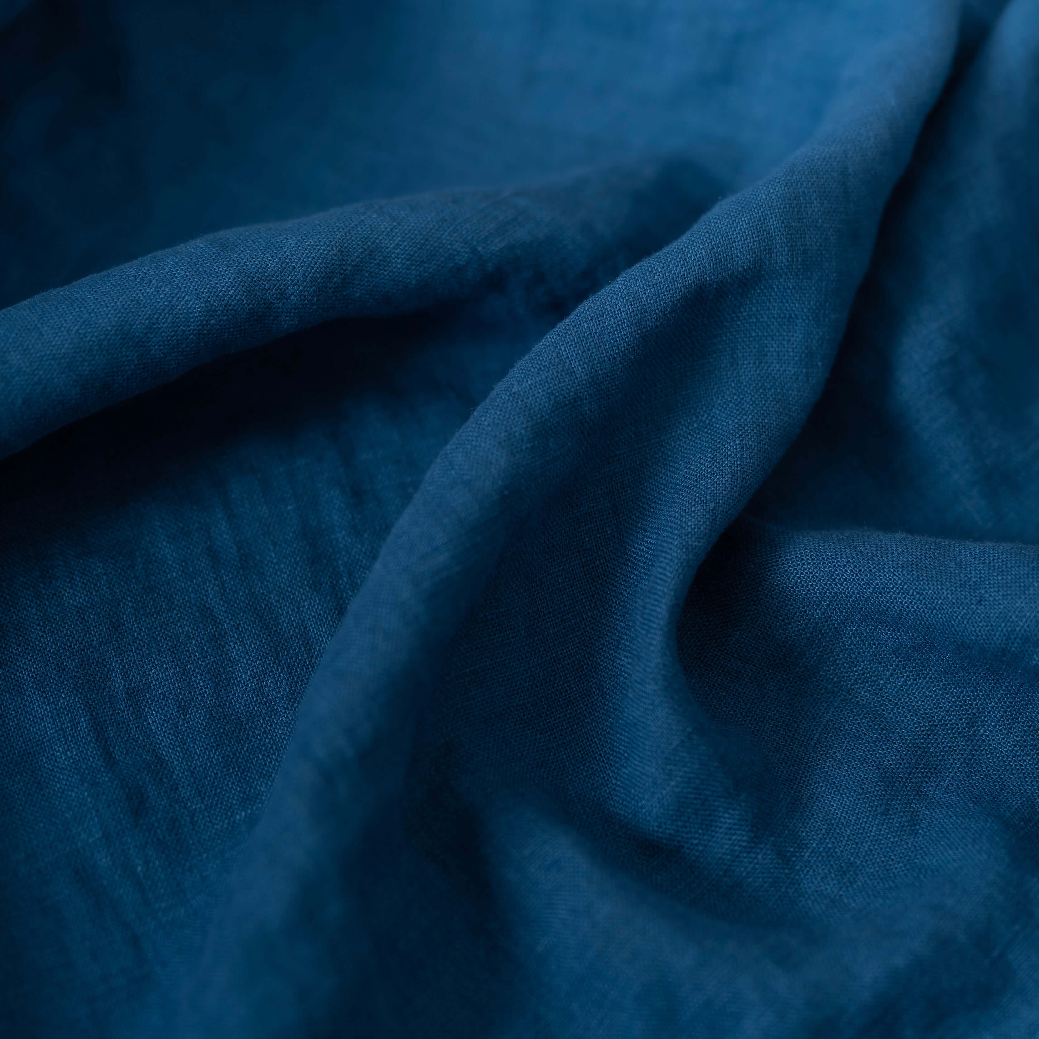 Petrol Blue linen fabric, crumpled to show its natural texture, washed European flax