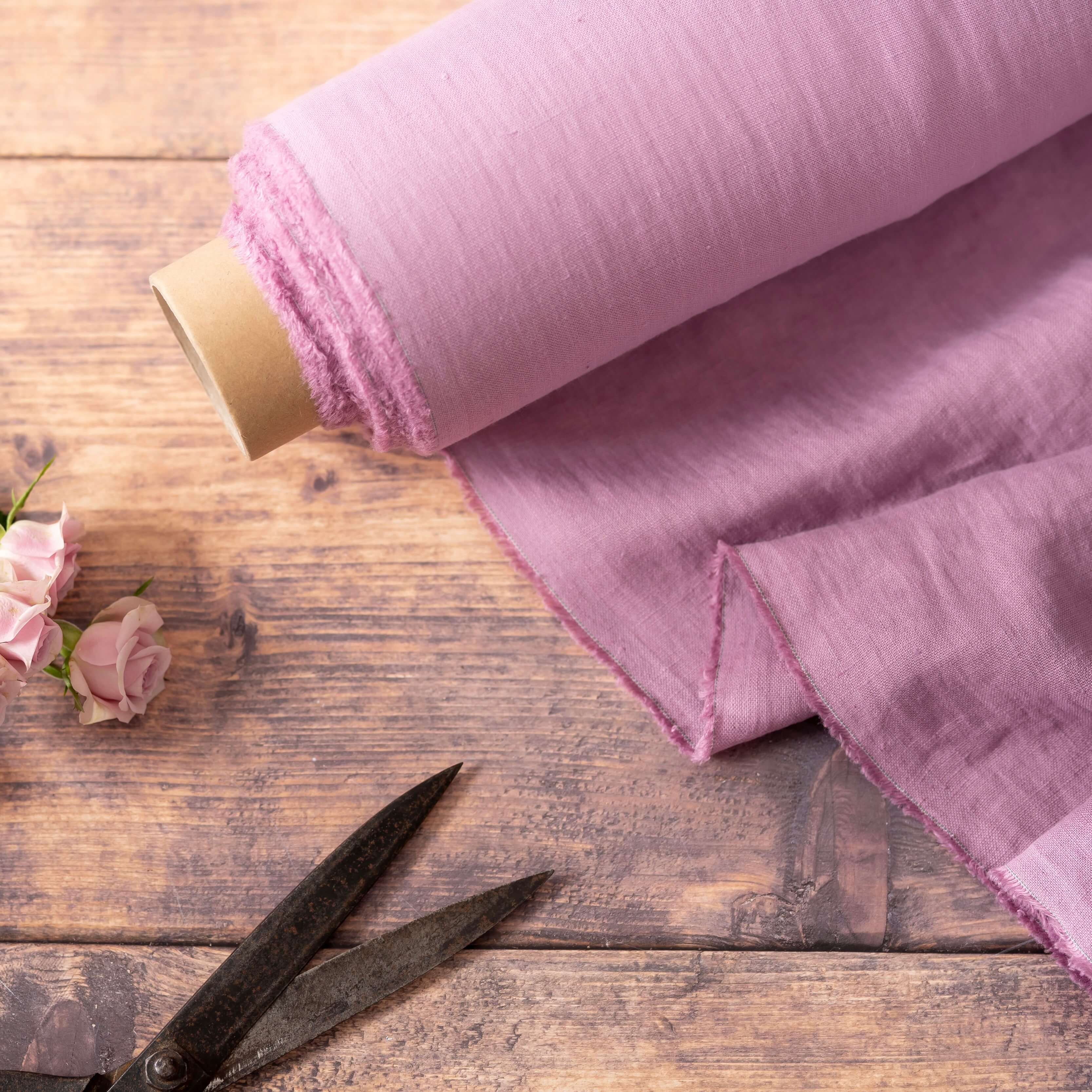 Pink Lilac linen fabric, ready to cut, with scissors, thread bobbins and flowers