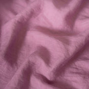 Pink Lilac linen fabric, crumpled to show its natural texture, washed European flax