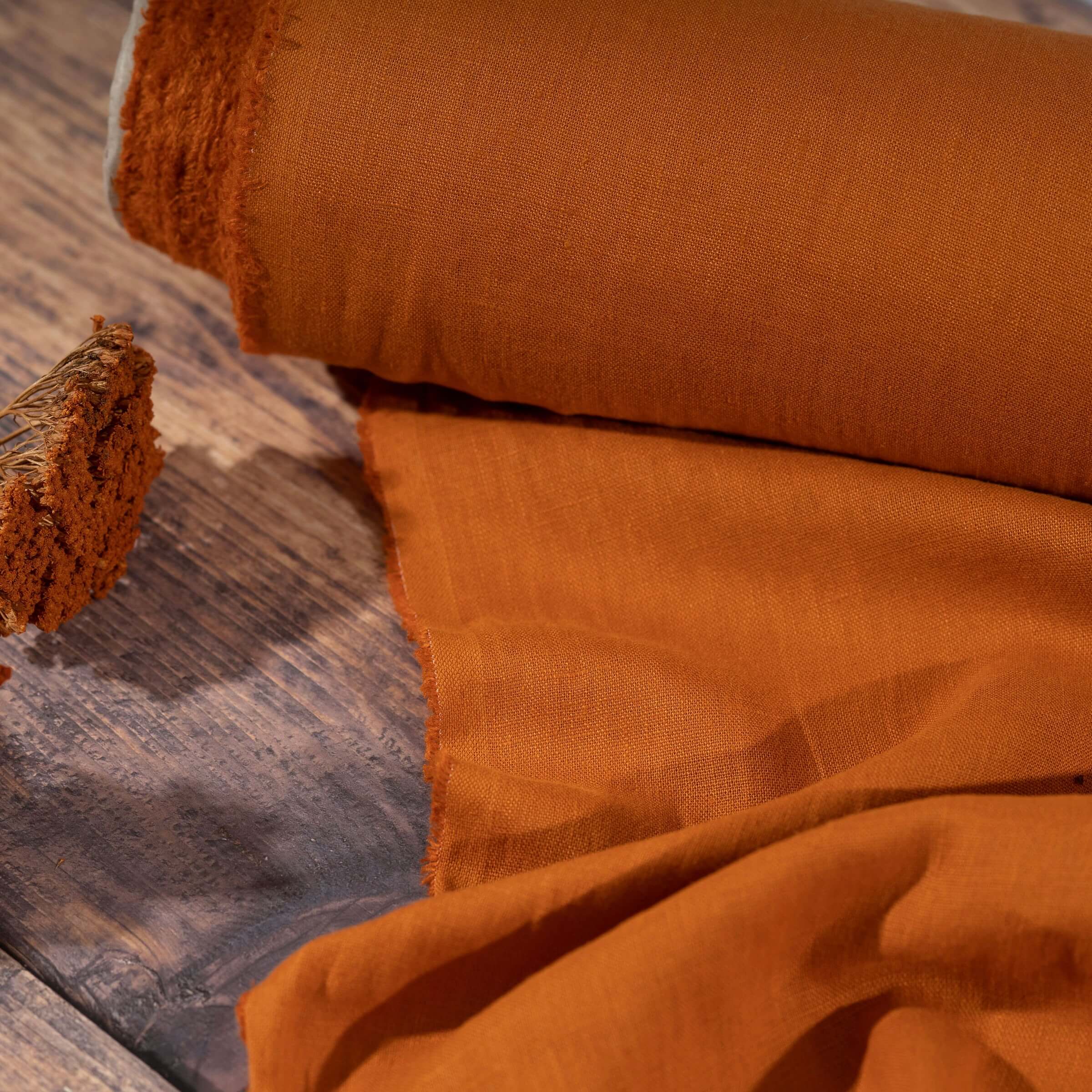 Pumpkin Orange linen fabric, ready to cut , on wooden table with flower