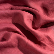 Raspberry linen fabric, crumpled to show its natural texture, washed European flax