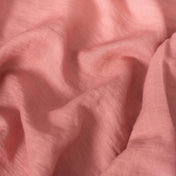 Rose Pink linen fabric, crumpled to show its natural texture, washed European flax