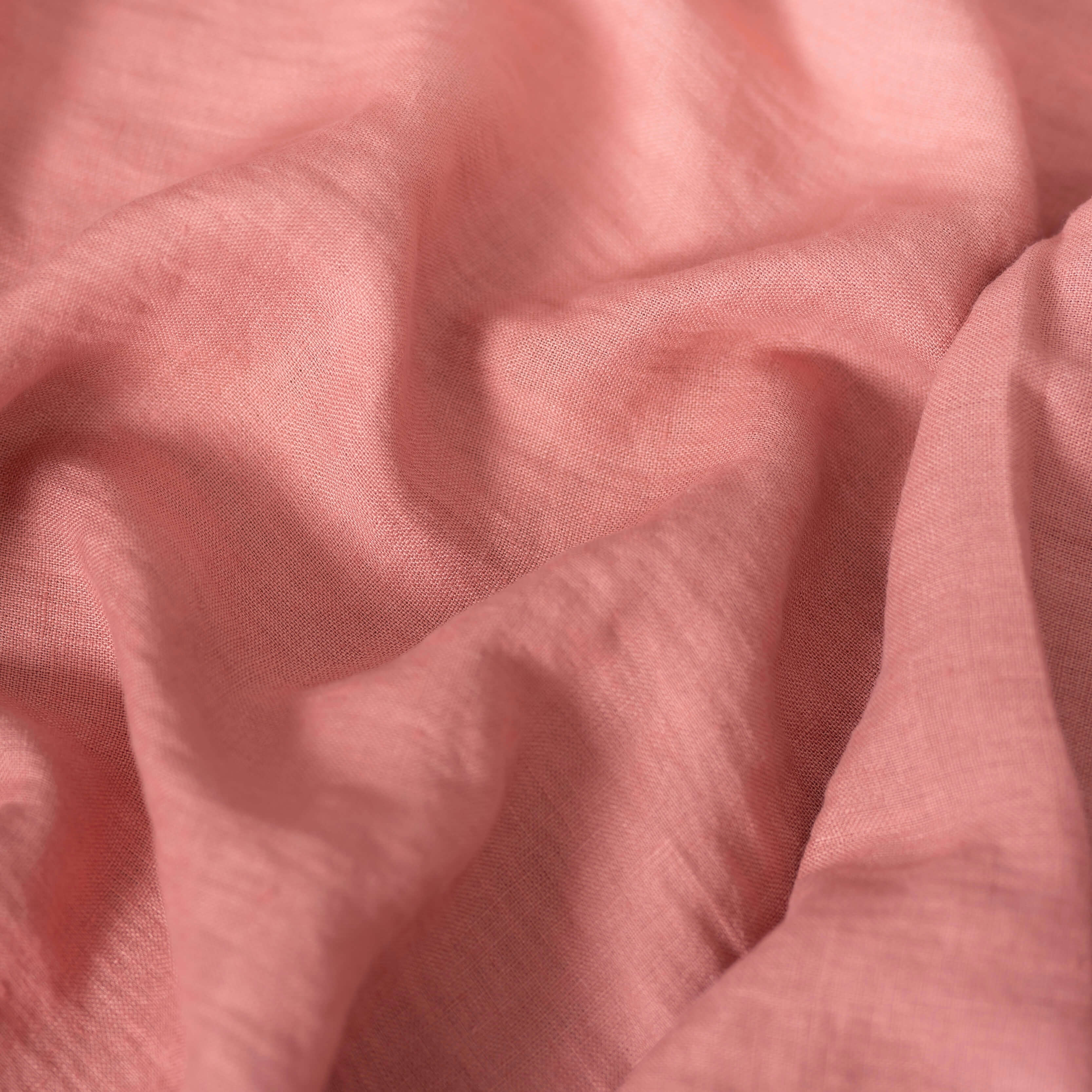Rose Pink linen fabric, crumpled to show its natural texture, washed European flax