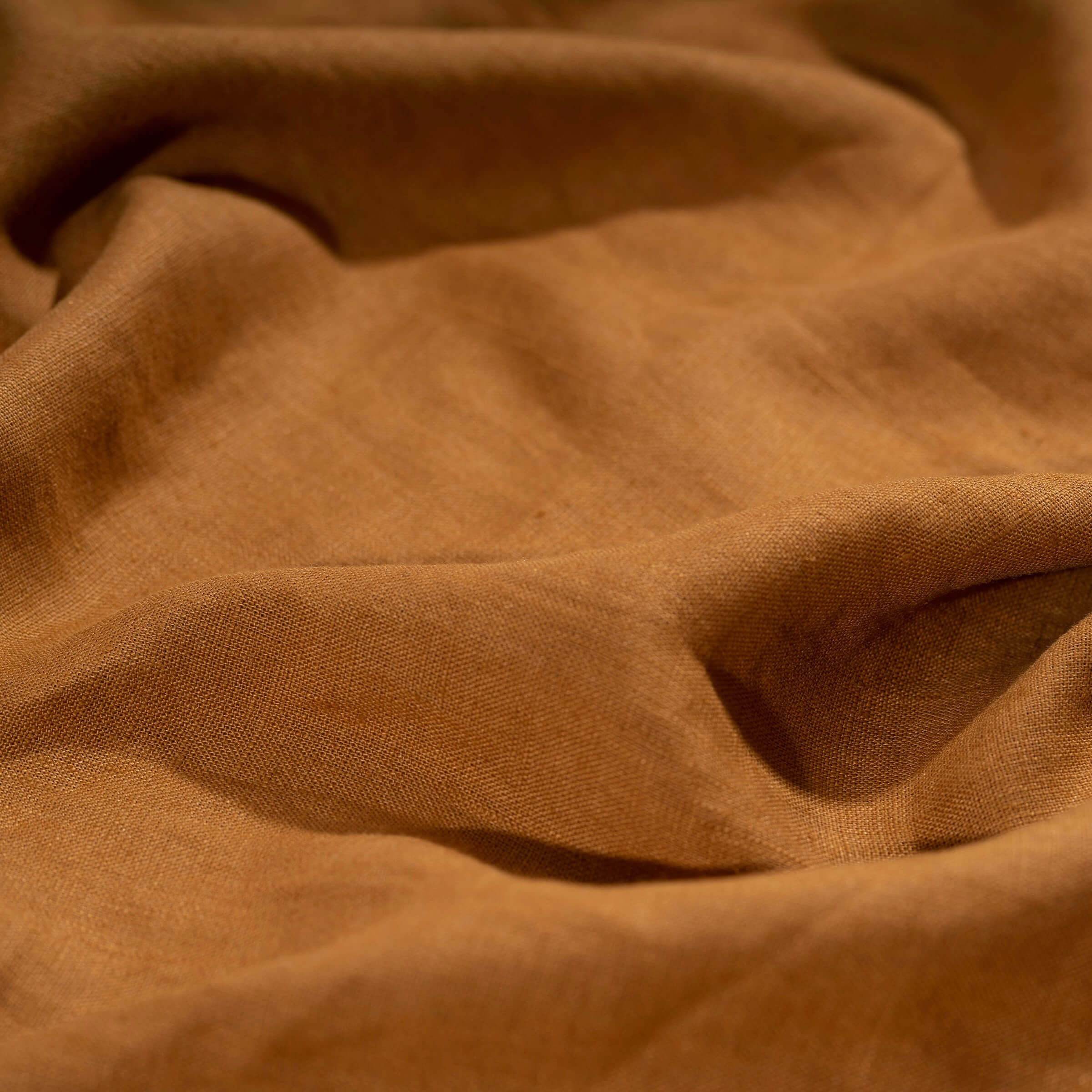 Rust Brown linen fabric, crumpled to show its natural texture, washed European flax
