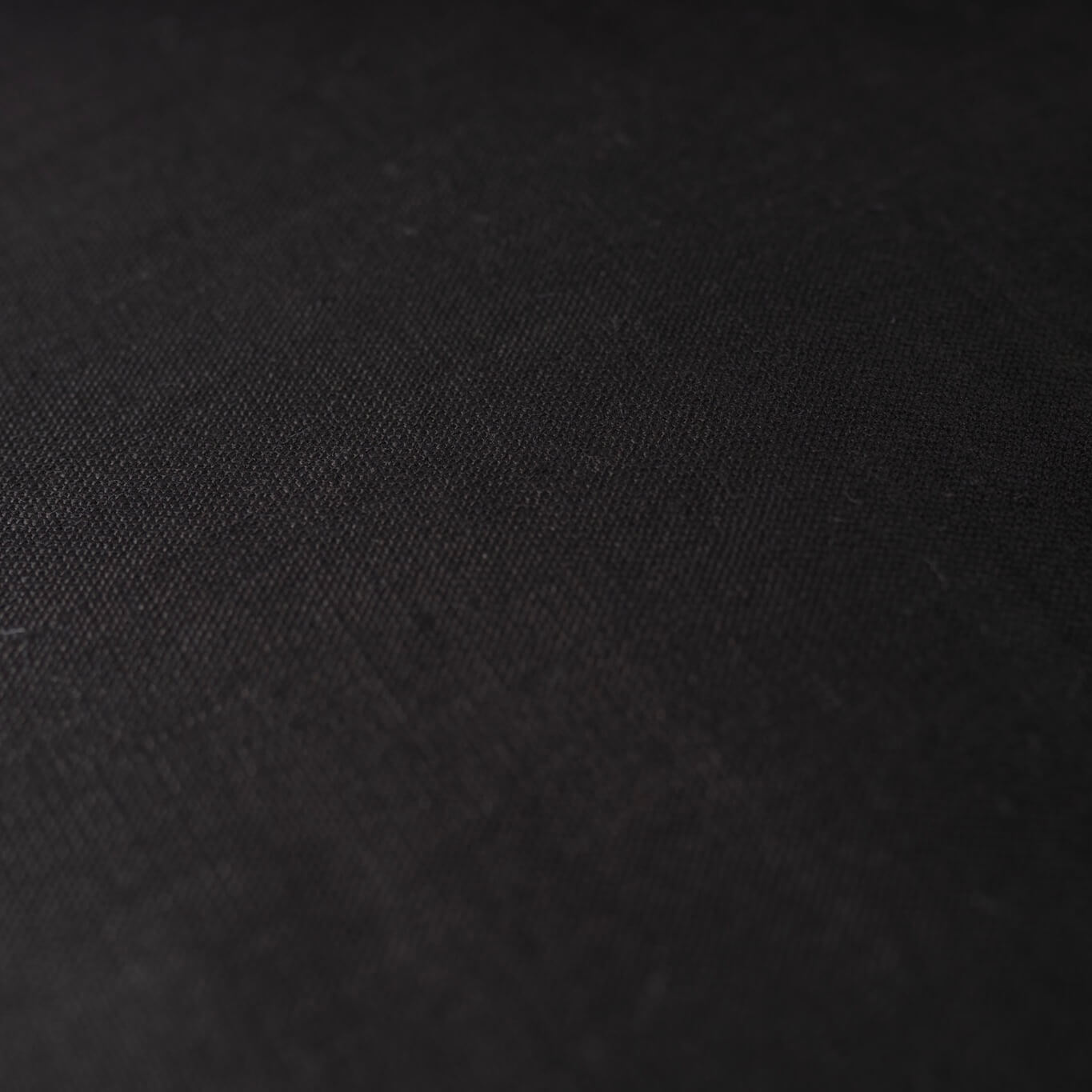 Close up of black cushion cover stonewashed fabric