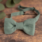 Dusty turquoise linen bow tie on wooden table