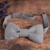 Baby blue linen bow tie on wooden table