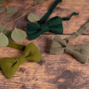 Collection of green linen bow ties in wooden table