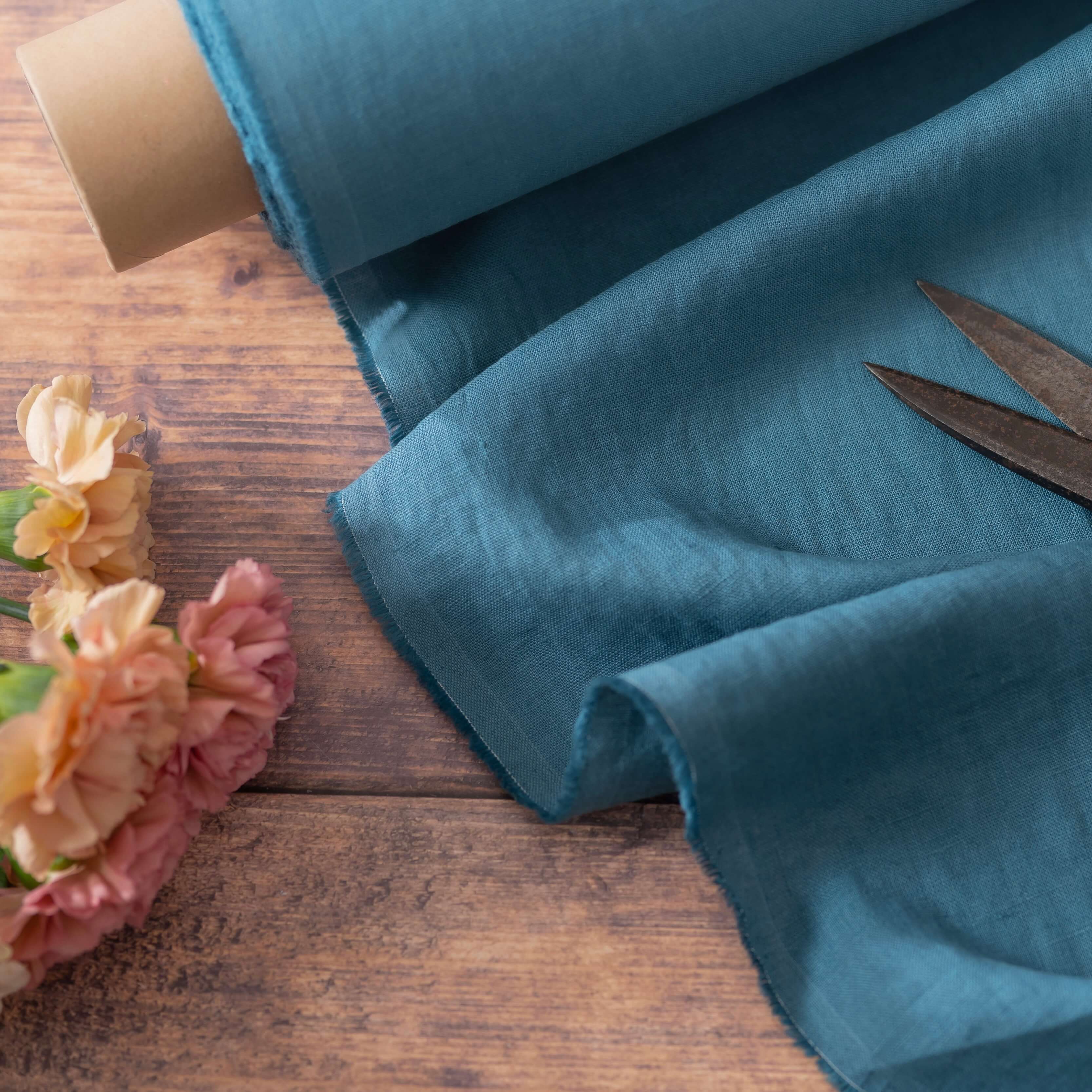 Turquoise Blue linen fabric, ready to cut, with scissors and flowers