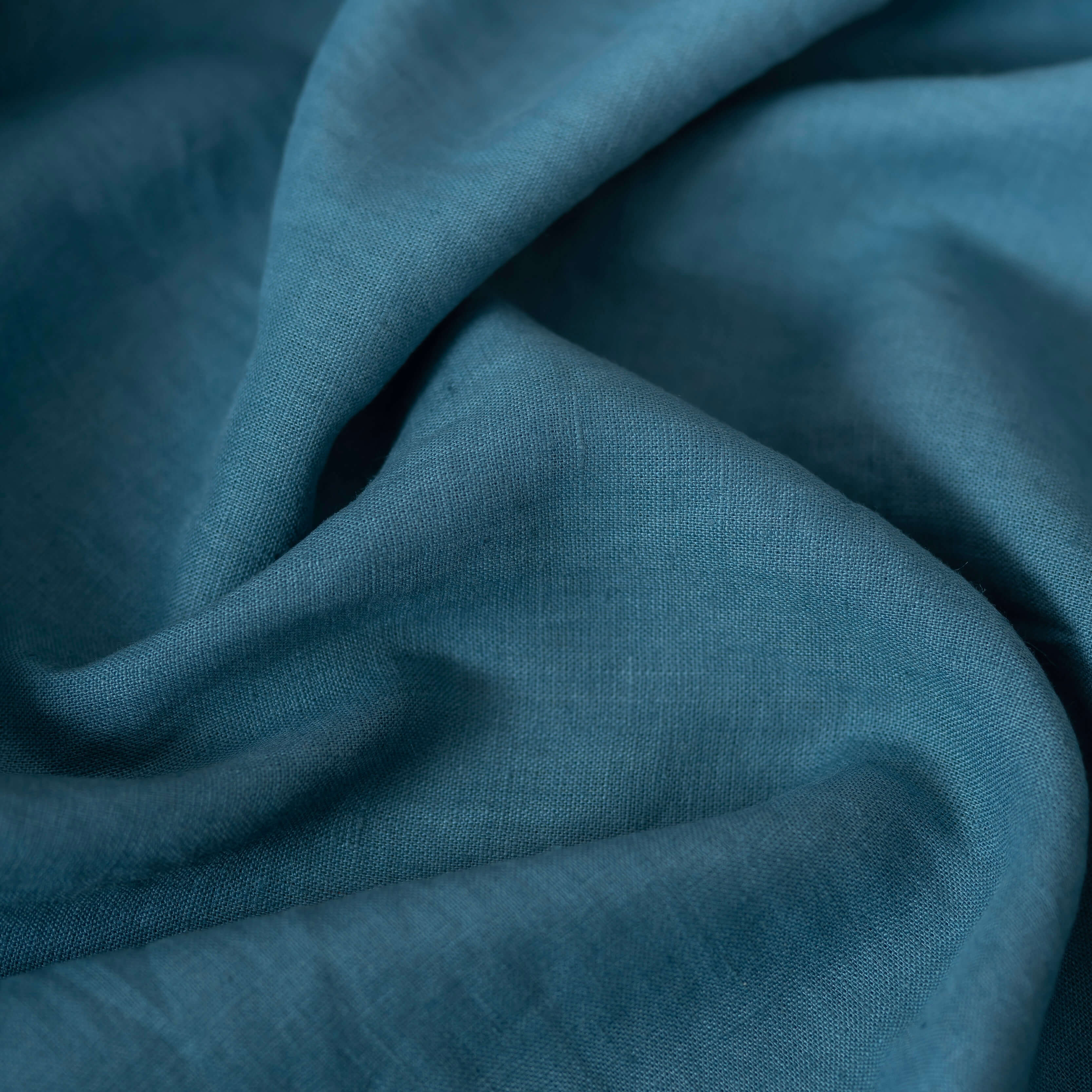 Turquoise Blue linen fabric, crumpled to show its natural texture, washed European flax